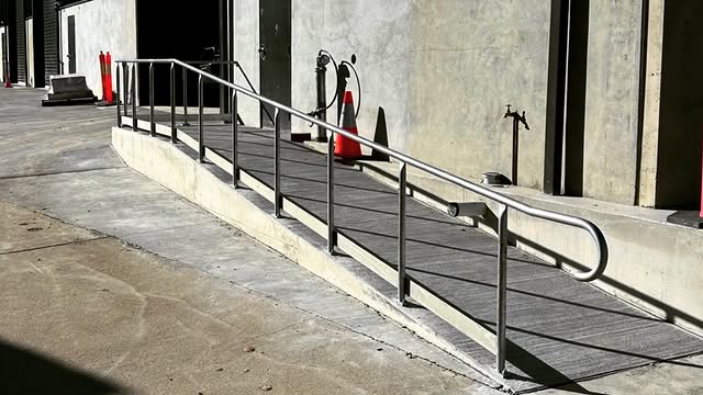 Stainless steel handrail on a commercial ramp