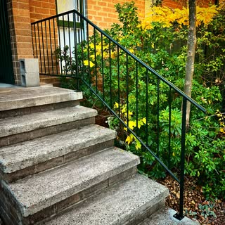 Black steel handrail on garden steps